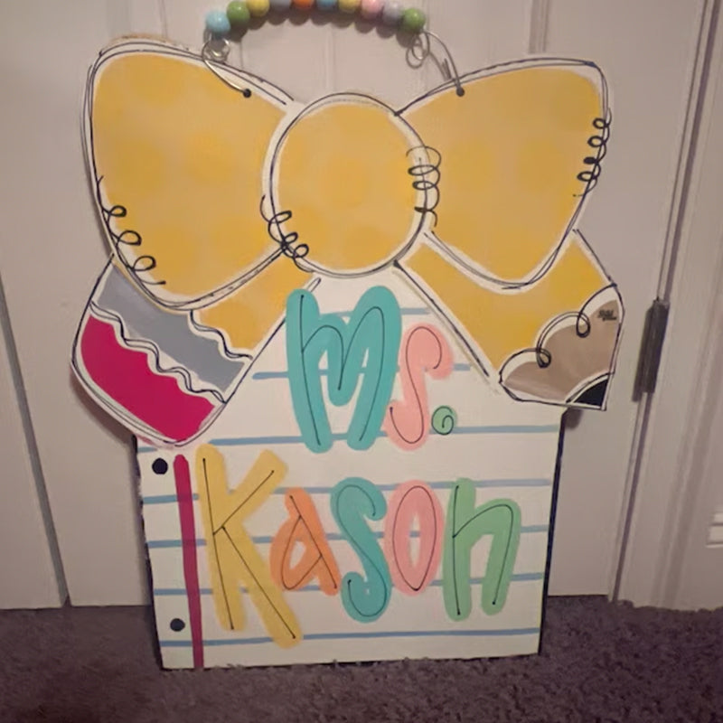 Notebook paper with pencil bow door hanger