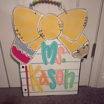 Notebook paper with pencil bow door hanger